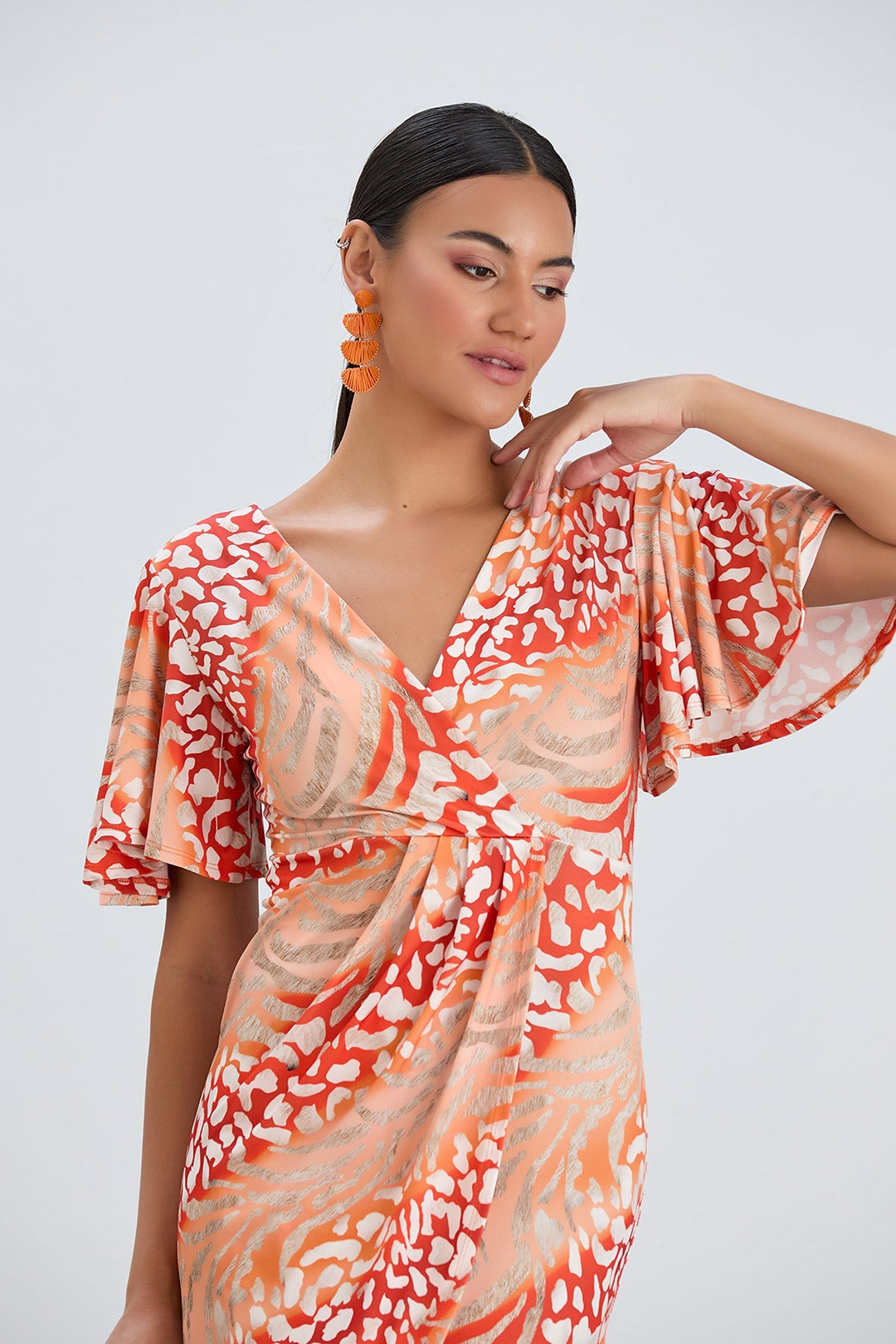 Flirty Flutter Sleeve Wrap Midi Dress in Orange Animal Print - jqwholesale.com